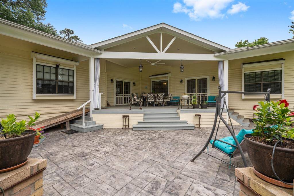 Another view of the spacious, inviting patio area with a covered porch. The stamped concrete flooring adds elegance, perfect for relaxing or entertaining.