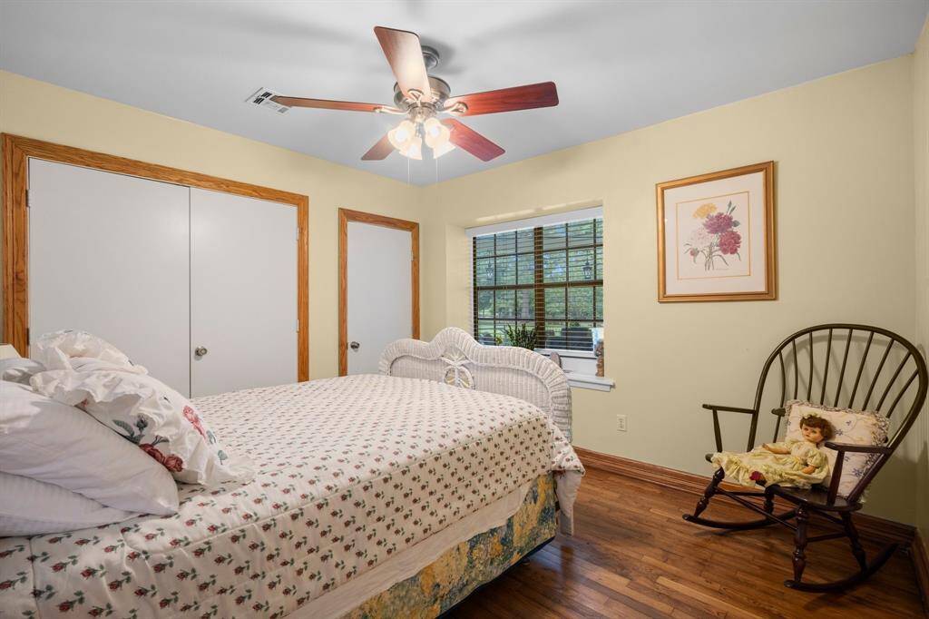Another view of the bedroom showing the window and double closet doors.