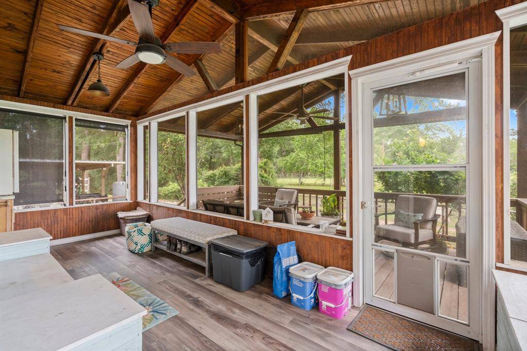 Just outside the kitchen and dining room, at the rear of the home, this wonderful custom built screened-in porch with lovely stained tongue-in-groove ceiling provides a relaxing indoor-outdoor living area.