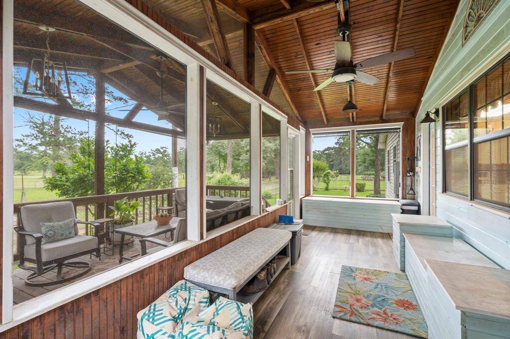 Another view of the screened in section of the back porch.