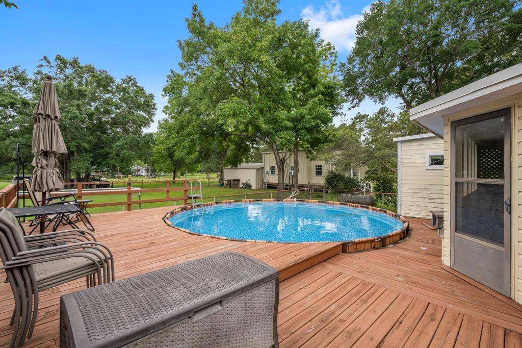 The spacious wooden deck with above-ground pool.