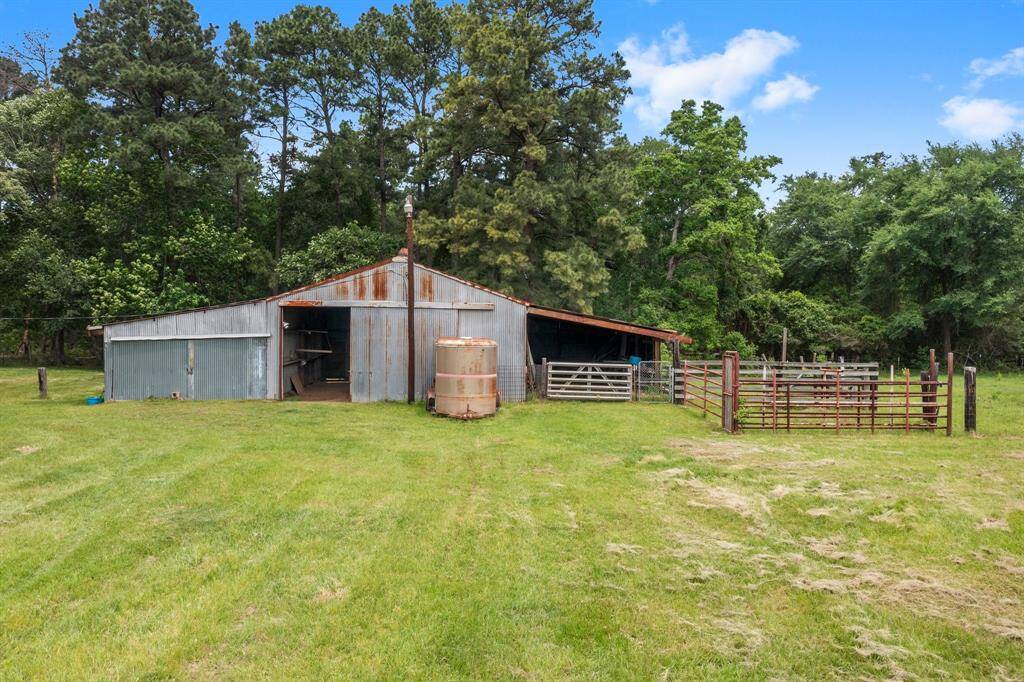 Rustic metal barn ideal for storing hay or shelter for animals.