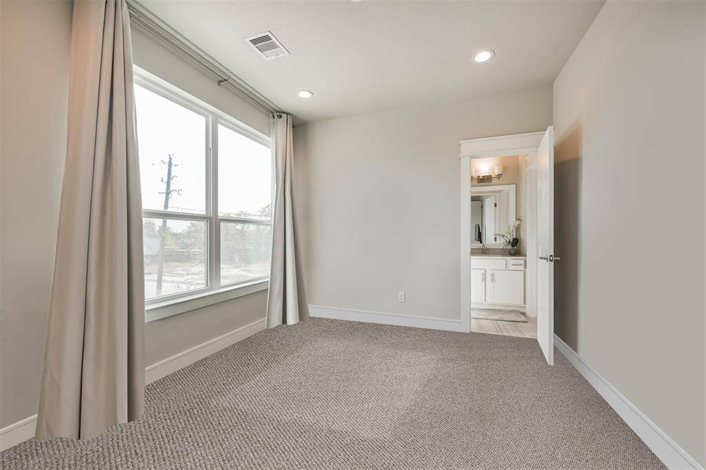 Second bedroom bathed in plenty of natural light with private en-suite bath.