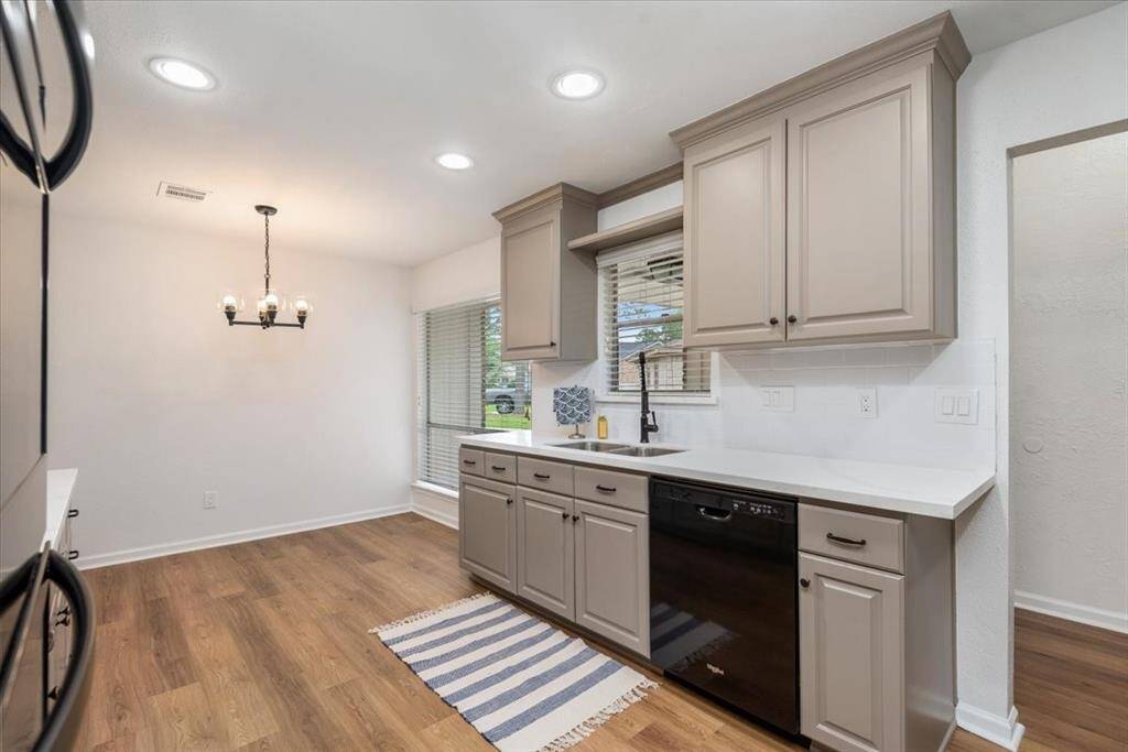 This photo showcases a bright and modern kitchen with a breakfast room.