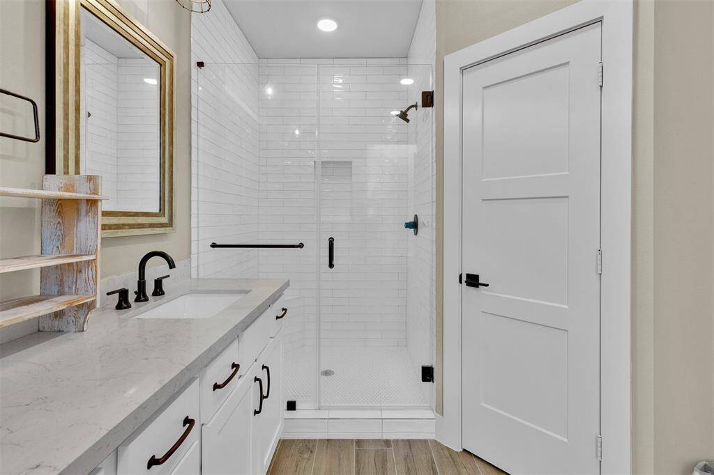 Oversized glass shower with floor to ceiling tiled walls!