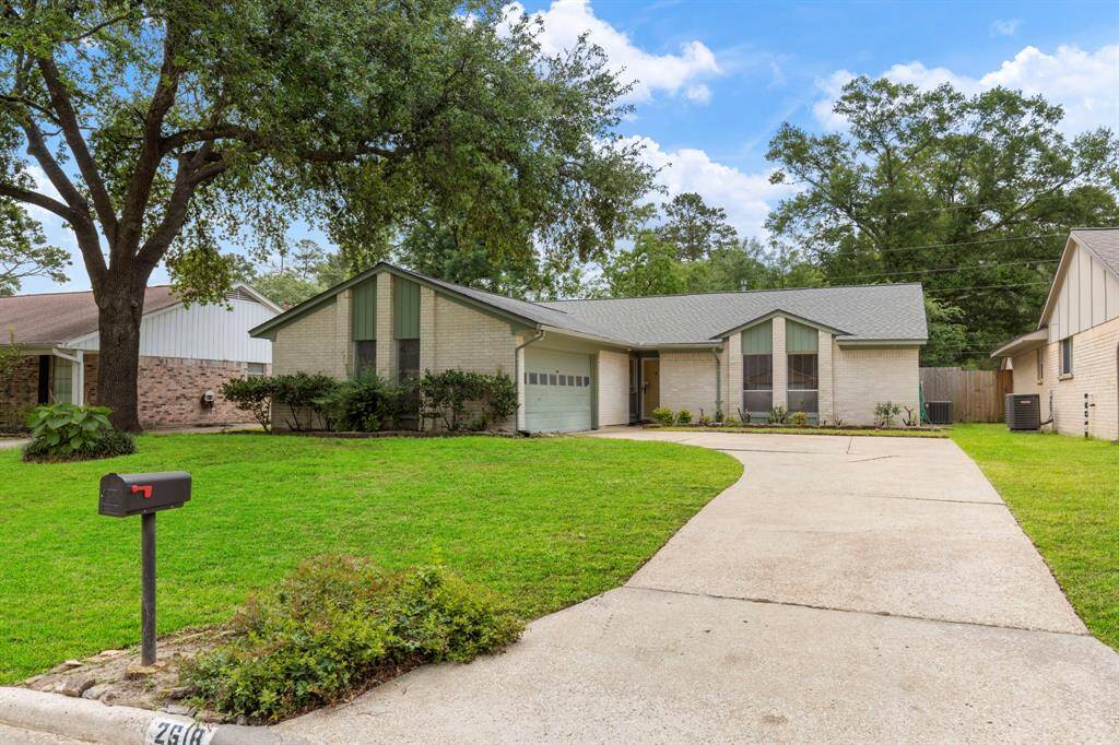 Large driveway leading to the two car garage