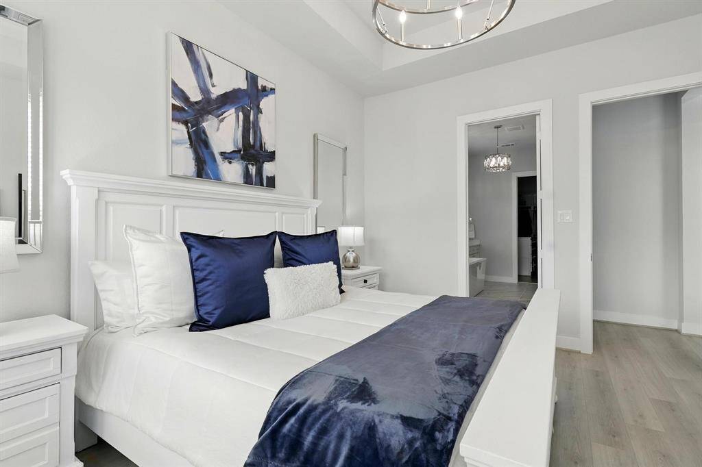A  modern laundry room with white cabinetry, a sleek countertop, and a stainless steel faucet. It features a washer and dryer, ample storagecreating a clean and functional space.