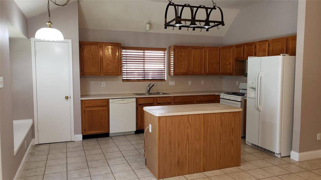 Another view of the island kitchen with all the appliances included! Countertops are now granite.