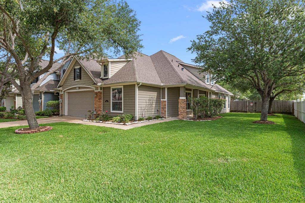 Features mature trees, a side yard (unique to this home in the neighborhood) and a private fenced backyard, offering both curb appeal and privacy.