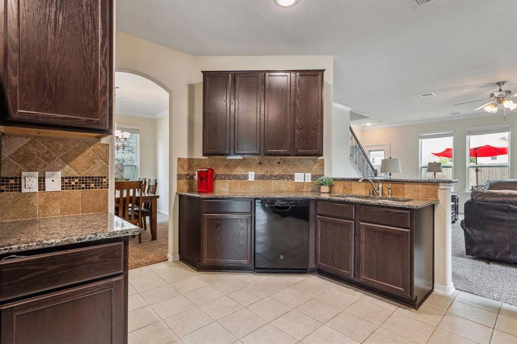 The kitchen features granite countertops and blank appliances