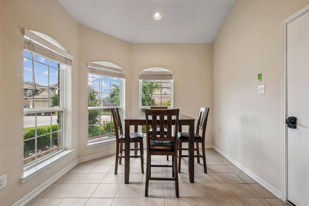 Through the kitchen is the breakfast room, located in the front of the home. Door to the right leads to the garage