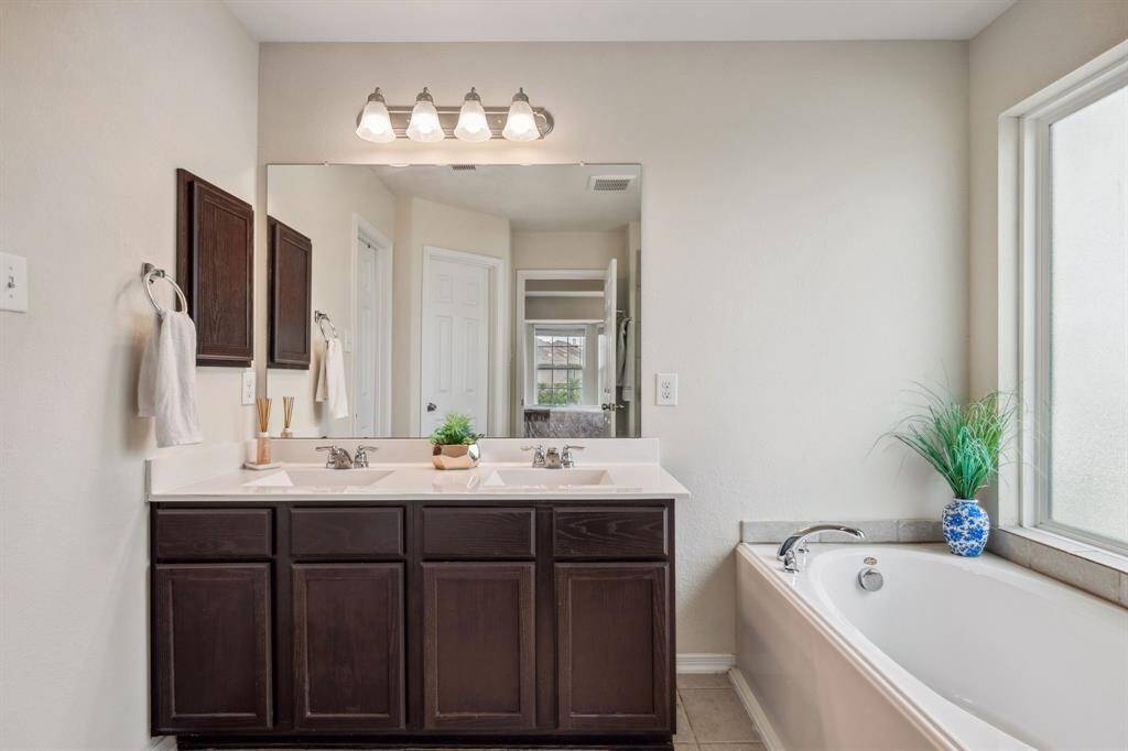 The primary bath was upgraded to included dual sinks. It has a large soaking tub and separate shower.
