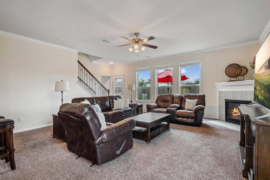 The living room can accommodate all types of furniture and has a ceiling fan for those warm summer days and a cozy fireplace for those winter nights