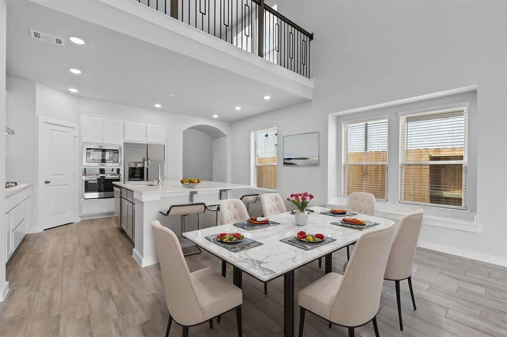 The open-concept living, dining, and kitchen area is perfect for entertaining—keeping the conversation flowing and the party going without missing a beat. Gather with family and friends while preparing a fabulous meal in the breathtaking kitchen, designed to be both beautiful and functional.