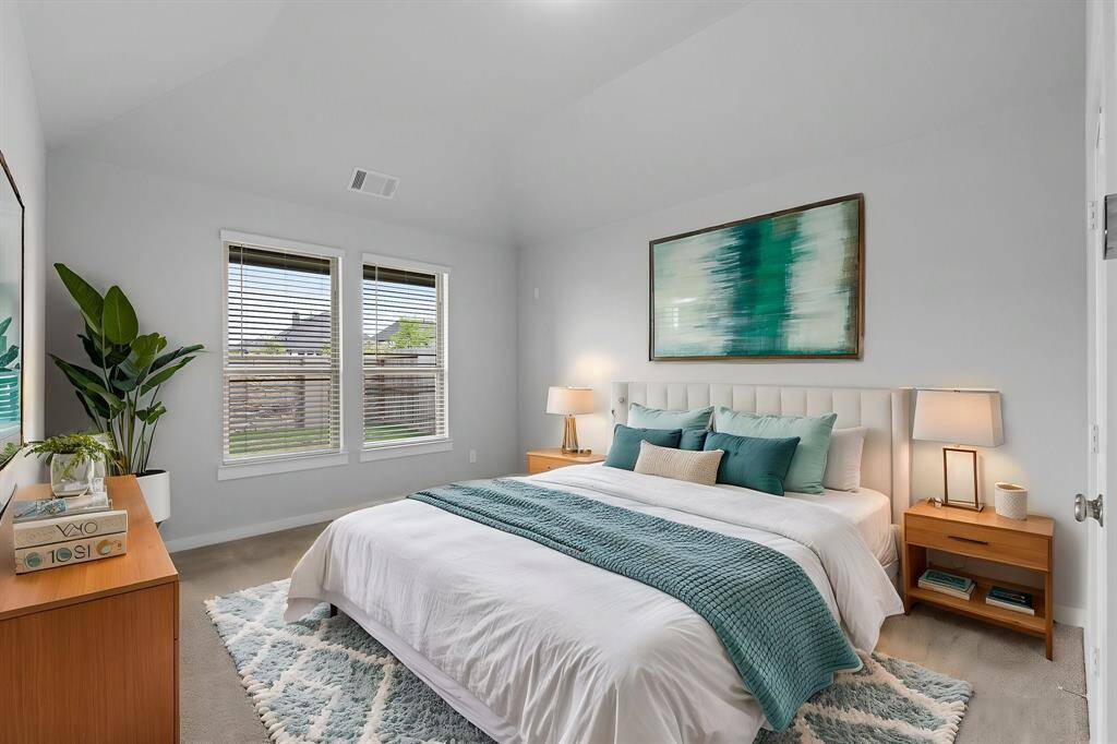 What a wonderful place to come home to—this stunning primary suite welcomes you with soaring ceilings and generous space, creating the perfect setting for your own personal oasis. PHOTO VIRTUALLY STAGED.