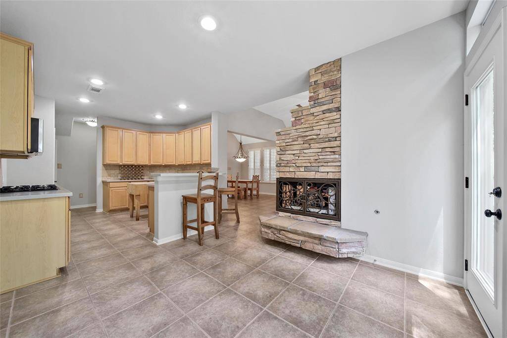A breakfast bar around the kitchen provides additional seating and serving space while keeping the kitchen open to the family room.