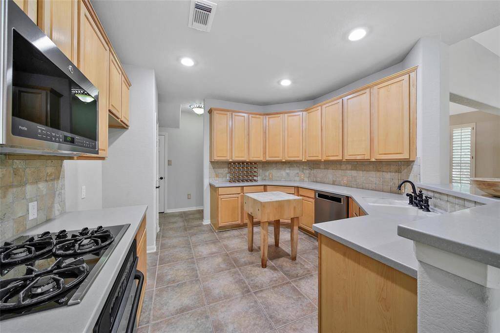 Ample cabinet and counter space with room for a moveable island makes this kitchen exciting to work in.