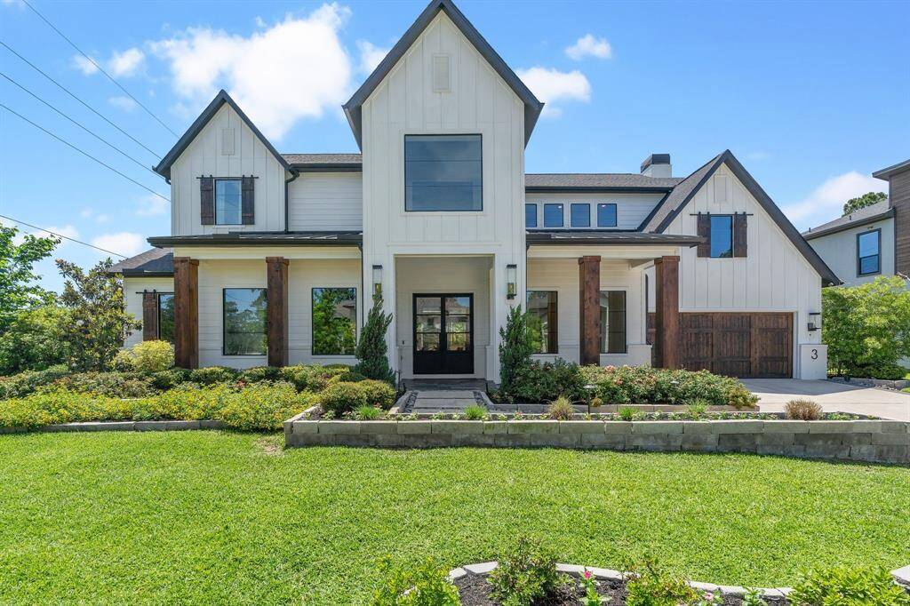 Crisp, clean, and timeless—this modern farmhouse stuns with its dramatic gables, rich wood accents, and black-trimmed windows. Situated on a beautifully landscaped corner lot, the home offers a commanding presence with a welcoming front entry and picture-perfect symmetry.