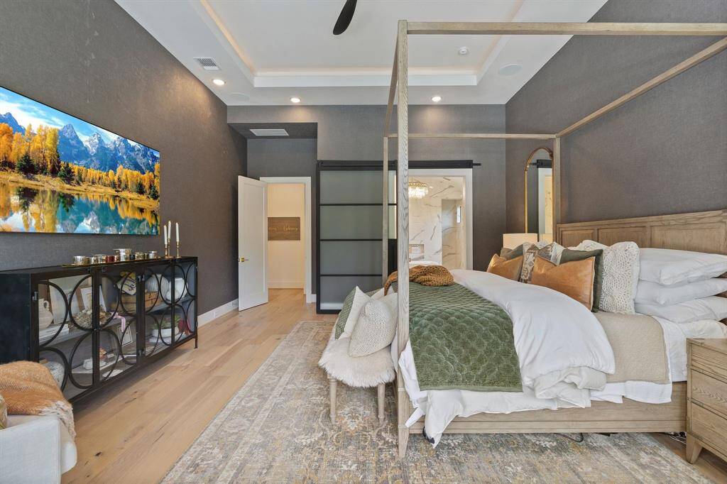 Tranquil atmosphere in this spacious primary suite, while the view into the spa-like bathroom hints at luxury throughout.