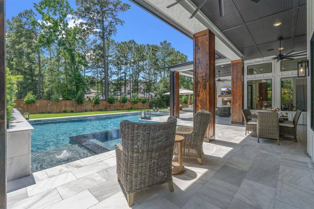 Welcome to your outdoor oasis where there are 4 sitting areas among the Snow White travertine decking.