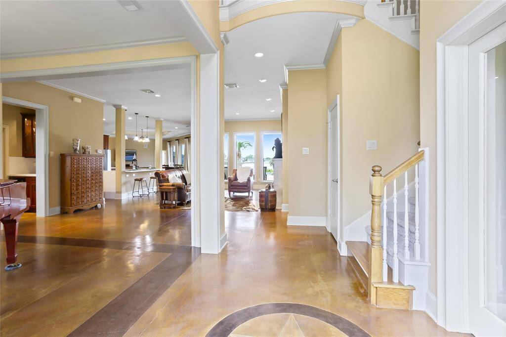 Upon entering, you're immediately greeted with stunning lake views that set the tone for this open-concept layout, designed to create a warm and inviting atmosphere. Ample natural light fills the home, and the living area offers a cozy setting, perfectly framed by picturesque outdoor views and complemented by stylish finishes at every turn.
