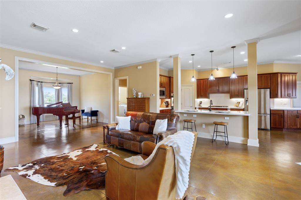 The open-concept living area flows seamlessly into the kitchen, creating an ideal space for entertaining and fostering a natural connection between the two areas.