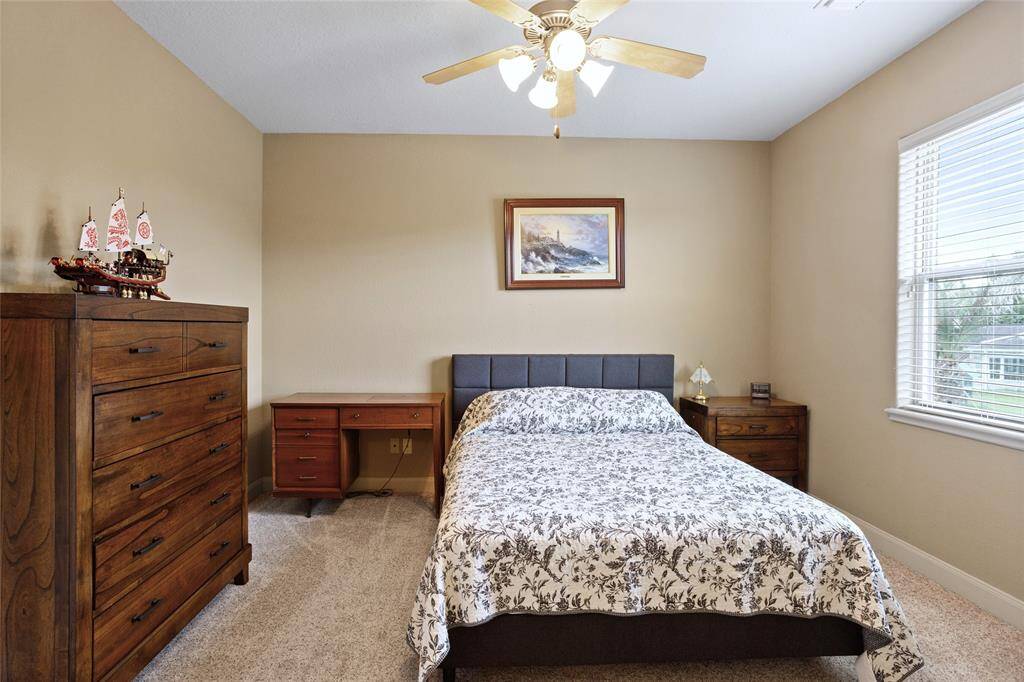 This cozy upstairs bedroom includes an ensuite full bathroom, offering added privacy and convenience for a comfortable living experience.