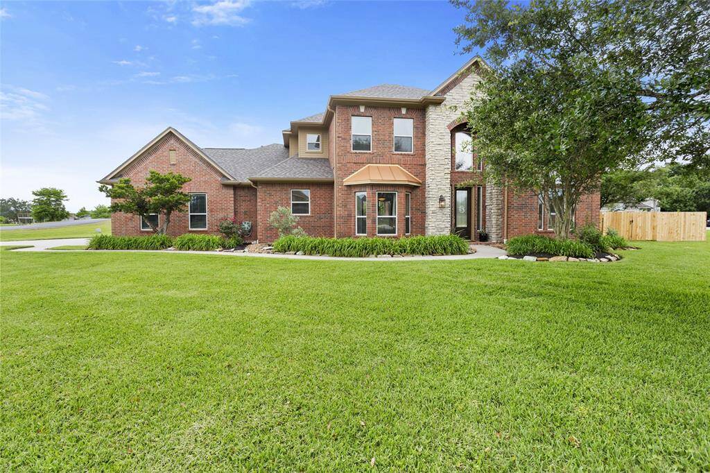 This beautifully maintained two-story brick home features charming stone accents, a welcoming front entry, and manicured landscaping with great curb appeal.
