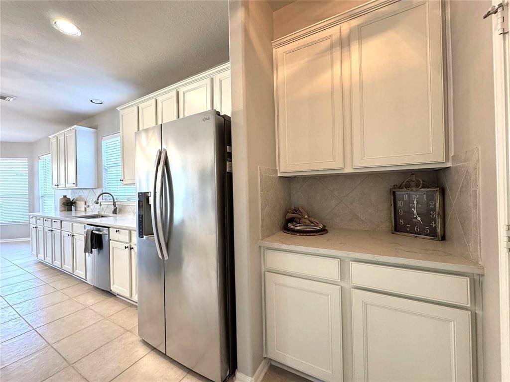 View of the Butler's Pantry. The S/S side-by-side refrigerator stays
