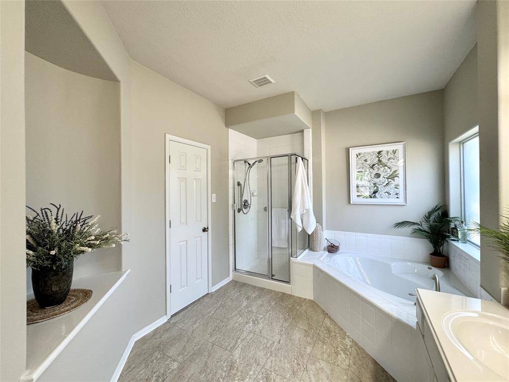 Primary Bath (view of soaking tub, separate shower, and art niche.