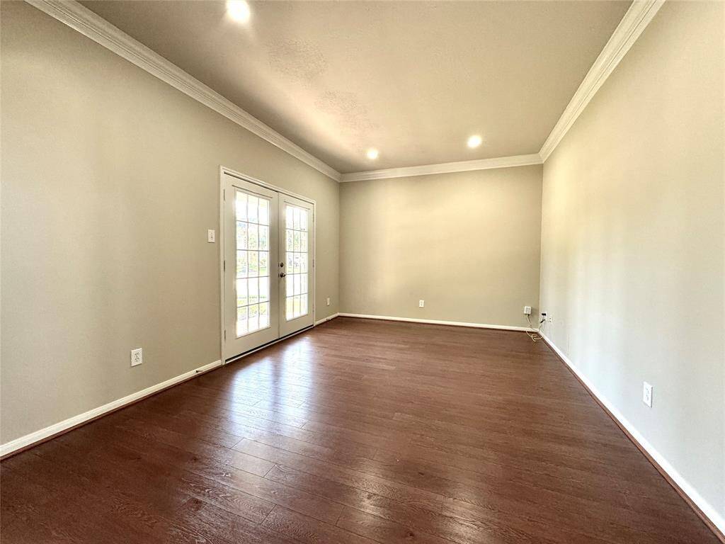 Home Office features wood flooring, high ceilings with crown molding, recessed lights, and ample natural light from French doors that lead to the covered front porch. Flexible space...could be a formal living room, playroom, or workout area...you choose.