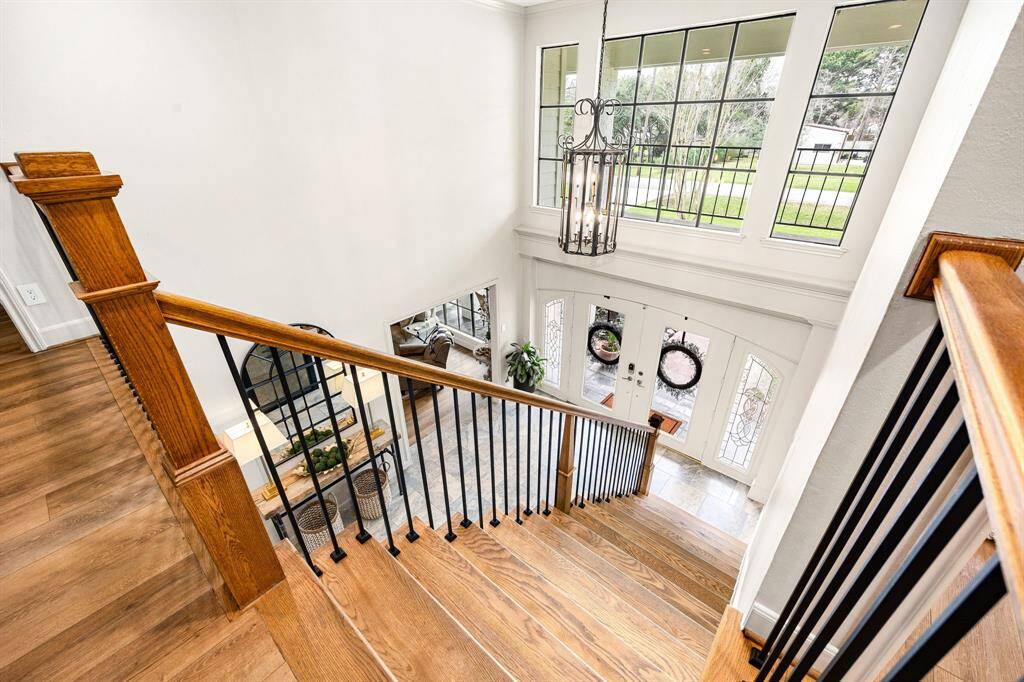 The elegant front entrance welcomes you to a beautifully renovated staircase leading to four spacious bedrooms, each with oversized walk-in closets. The second floor also features two newly updated bathrooms, a media room, a generously-sized game room, a cozy lounge area between two bedrooms, and an expansive balcony with stunning views.