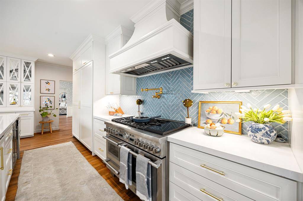 This fully renovated kitchen boasts top-of-the-line Thermador and Liebherr appliances, dual sinks, a convenient pot filler, soft-close drawers and cabinets, sleek quartz countertops, and an array of premium upgrades!
