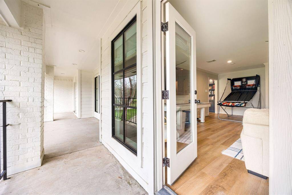 The upstairs game room opens to a spacious balcony, offering plenty of room for outdoor furniture and a separate area to relax and unwind.