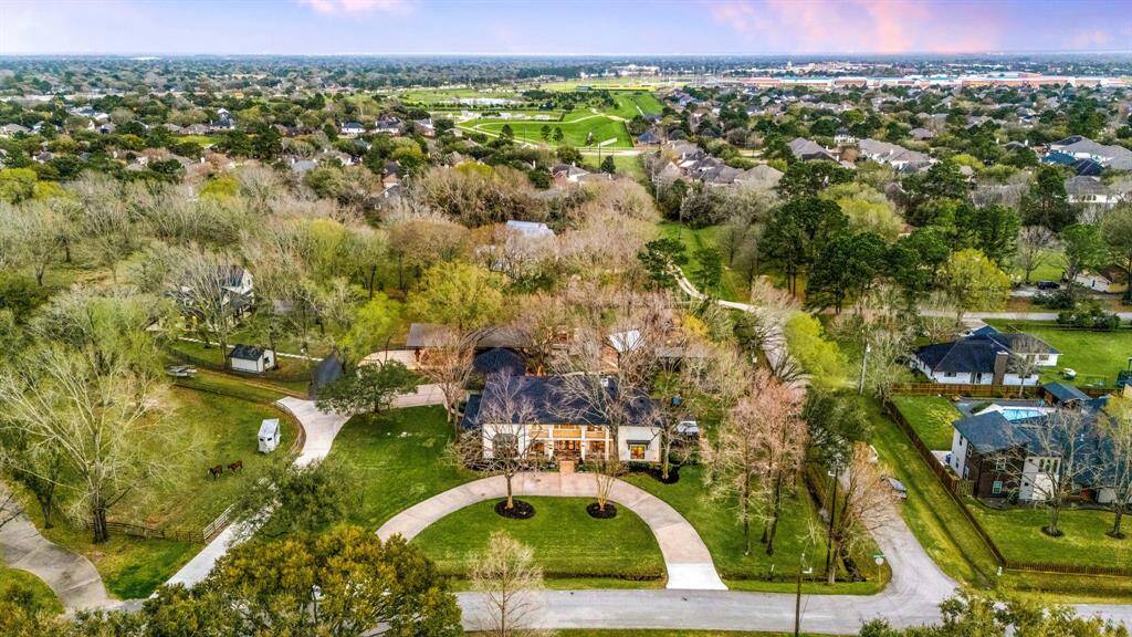 Aerial view of this magnificent estate. 5947 sq ft home with circular driveway. Surrounded by established neighborhoods and no surprises beyond your property line.