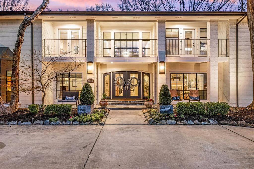This stunning two-story home features a welcoming double-door entry, ample windows for natural light, and expansive balconies. The freshly landscaped front yard includes well-maintained shrubs and a circular driveway, creating an inviting curb appeal.
