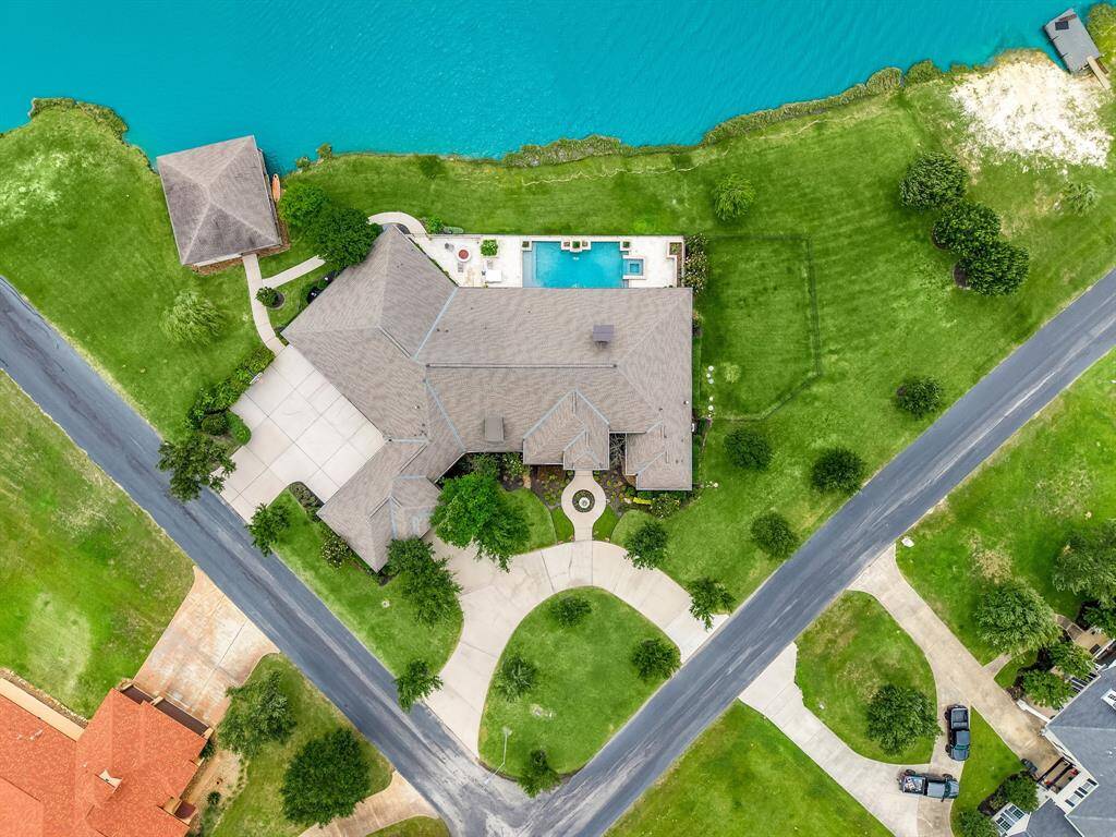 Circular driveway and a separate entrance point to your 5-car garage with a walking path to your dual boat slip.