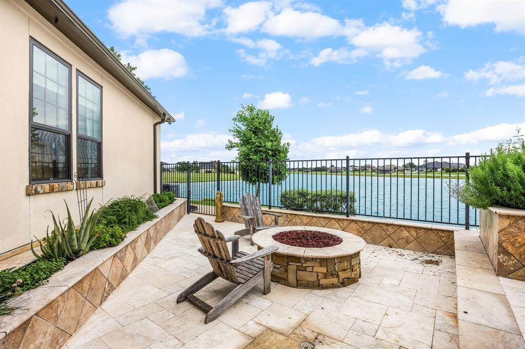 Enjoy the firepit on a crisp cool evening. Herbs are being grown in the planter bed under the recently-replaced Pella windows.
