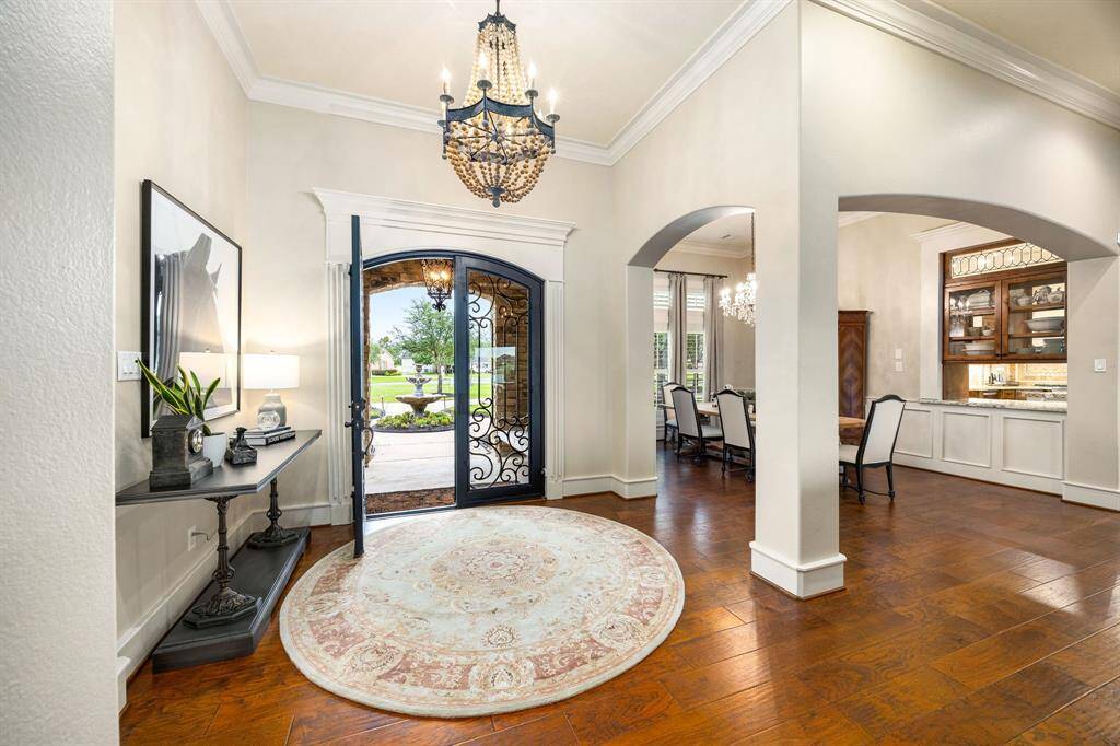 Elegant foyer with double iron doors lead into the designated formal dining room.
