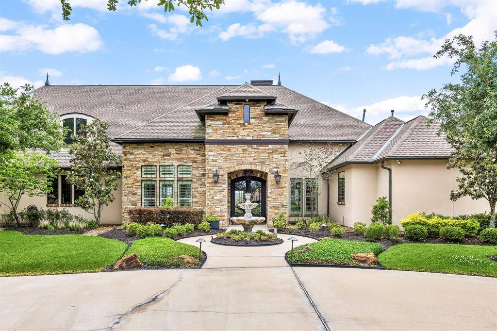 This custom home makes a striking first impression with it's timeless architecture, pristine landscaping, and expansive driveway.