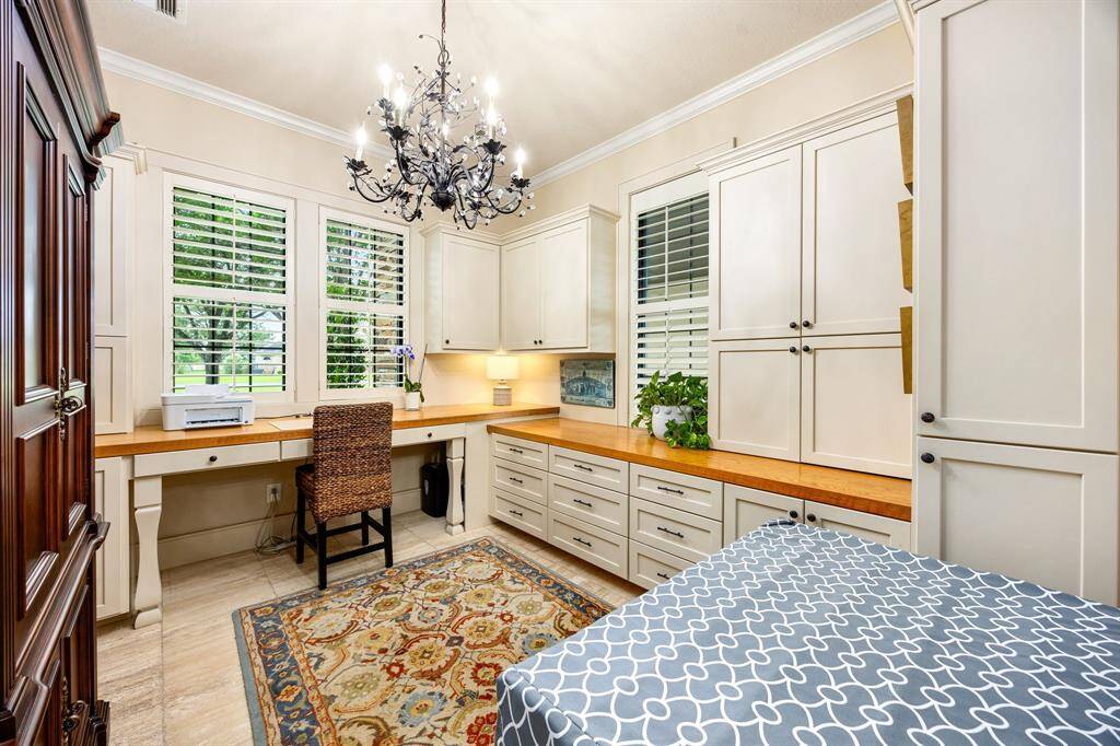 This second office space located just off the mudroom features custom cabinetry to keep your household organized.