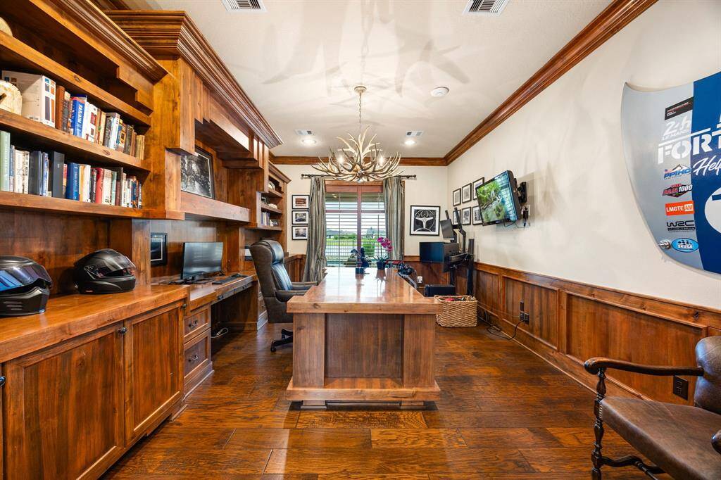 Study located on the opposite side of the house from the secondary bedrooms and game room area. Custom built-in cabinets and desk are stationary.