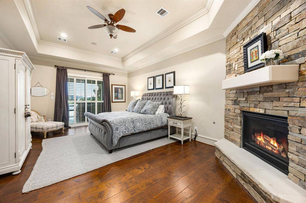 The primary suite includes a spa-inspired bathroom, cozy fireplace and spectacular lake views.