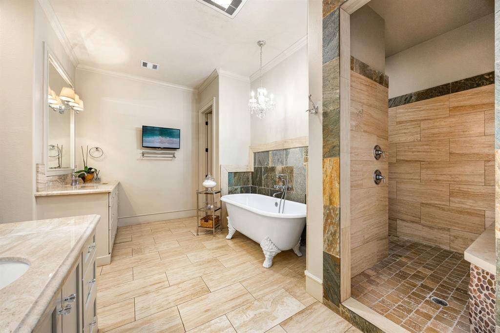 Here's another angle of the primary bathroom featuring double sinks—perfect for getting ready together. The separate water closet adds a touch of privacy with its custom toilet design.