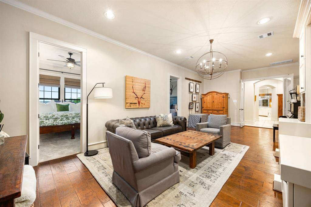 This lounge and game room space is located between three secondary bedrooms on the opposite side of the home from the primary suite.