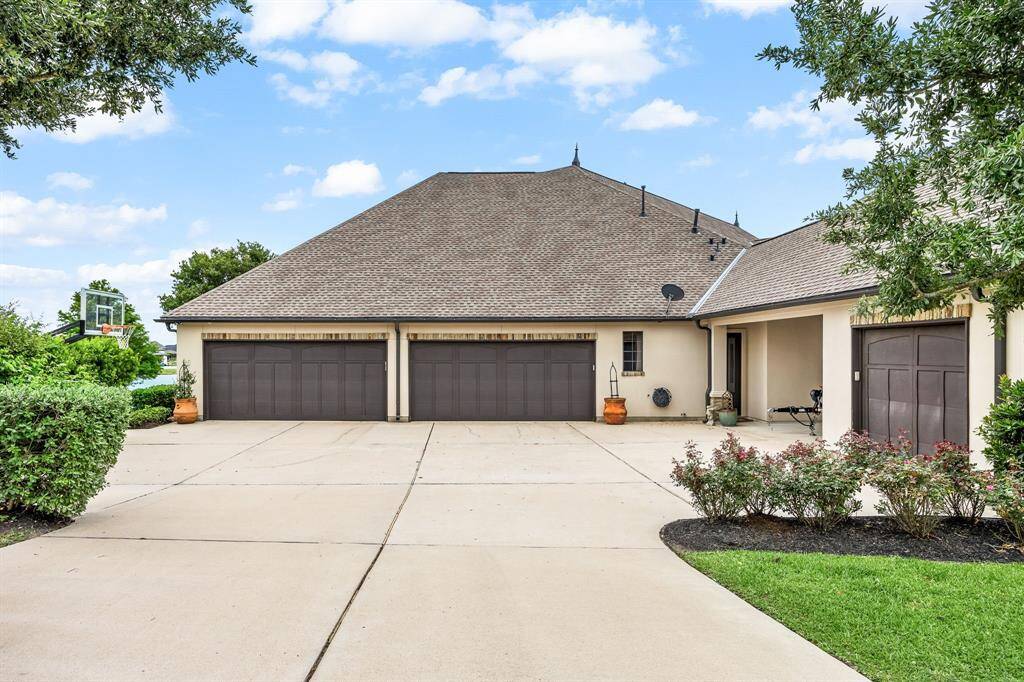 Rare 5-car garage and porte-cochere supports a large household and an active livestyle. Basketball goal can convey with the property.