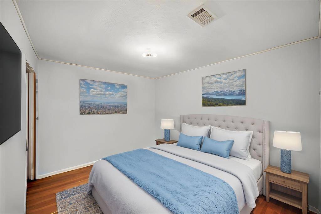 Virtually Staged: Secondary bedroom with wood floors.