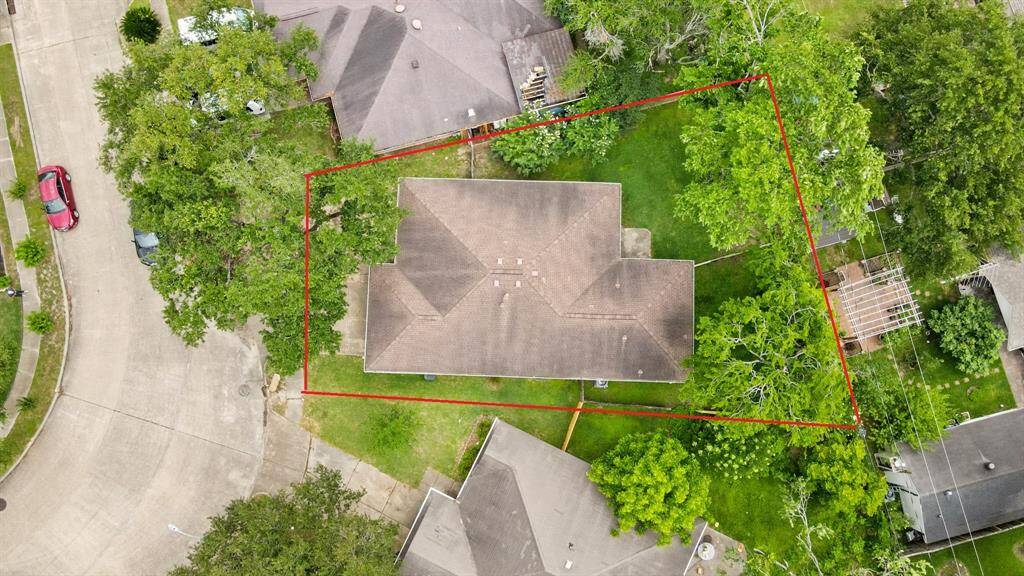 This aerial view showcases the 6,863 sqft lot with mature trees.