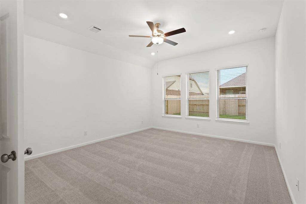 Another view of the Primary Oasis with wall of windows adding in natural lighting and also offering backyard views!