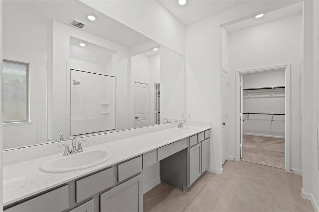 Primary Bathroom Oasis offers his and her sinks, vanity area to ensure getting ready in the mornings is a breeze, recessed lighting, extended mirror and more!